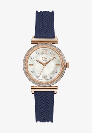 Rózsa arany ovális óra gyöngyház számlappal, hat gyémánt jelölővel, kék gumi pánttal és texturált halszálka mintával.