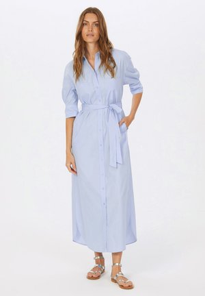 Light blue, long-sleeved button-up dress with a belted waist and side pockets. Smooth fabric with a straight cut and ankle-length hem.