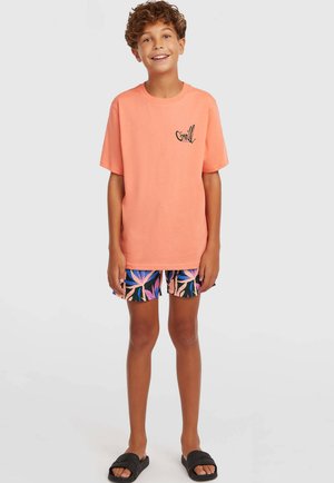 Pruunika värvi puuvillane t-särk tikitud logoga, mustade ja roosade troopiliste mustriga lühikeste pükstega ning mustade libisemissussidega.