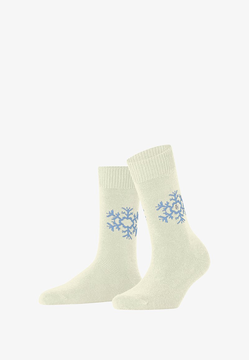 Chaussettes tricotées vert clair avec des motifs de flocons de neige bleus, des bords côtelés et une texture douce. Idéales pour les temps plus froids.