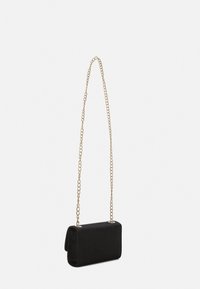 Black fabric handbag with a rectangular shape, featuring a gold chain strap and a smooth texture. Closure details are minimalistic.