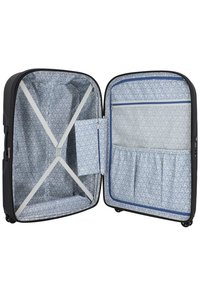 Valigia rigida nera con interno a motivo blu, dotata di cinghie incrociate, una tasca laterale e più scomparti interni.