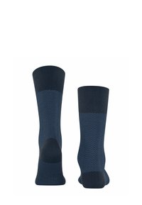 Calze blu navy con motivo a spina di pesce, con polsini a coste, talloni rinforzati e texture liscia. Design di lunghezza media, vestibilità standard.