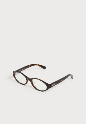 Ovale Schildpatt-Brille mit klaren Gläsern und dünnen Bügeln, an der Seite mit "QUAY" gebrandet, auf einer weißen Oberfläche platziert.