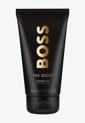 Tube noir de gel douche BOSS The Scent avec lettrage doré, capacité 150 ml (5,0 fl oz), bouchon à clapet.