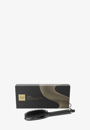 Elektrische schwarze glättende heiße ovale Haarbürste mit Borsten, gezeigt mit eleganter schwarzer und goldener Verpackung im Hintergrund.