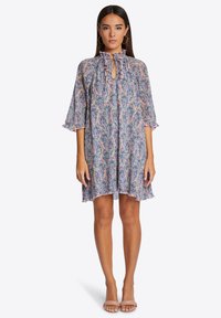 Printed A-line dress with ruffled neckline, keyhole detail, and elbow-length sleeves. Features a floral pattern in pink, blue, and green tones.