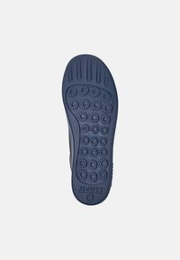 Sole of a dark blue shoe showing textured grip patterns and a size marking of 42, placed against a white background.