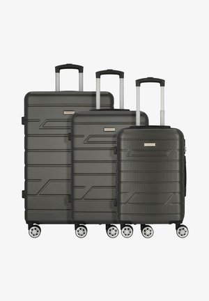 Set di valigie a tre pezzi in grigio scuro. Guscio rigido testurizzato con linee geometriche, manici telescopici e otto ruote per stabilità.