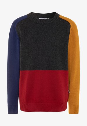 Farveblokstrikket sweater med mørkegrå øverste del, rød nederste front, marineblå venstre ærme og sennepsgul højre ærme. Ribstrikkede manchetter og krave.