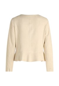 Beige imitace semiše s kulatým výstřihem, dlouhými rukávy a rozšířeným lemem. Obsahuje vertikální švy a boční rozpoly.