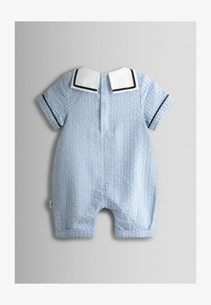 Mėlynos ir baltos dryžuotos trumpas kombinezonas su apykakle, sagų užsegimu ir juodu apdaila ant rankovių. Minkštas tekstūruotas audinys.