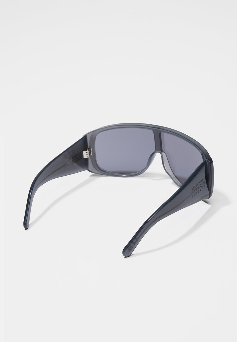 Sunglasses with a dark gray plastic frame, rectangular lenses, and a sleek design. Features a logo on the temple and a smooth texture.