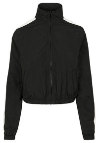 Jachetă neagră scurtă cu guler înalt, fermoar frontal, talie elastică și dungi albe pe laterale. Fabricată dintr-un material ușor și neted.