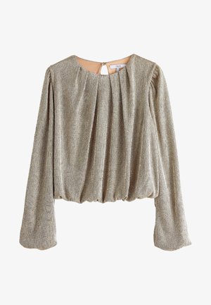 Blouse à manches longues en tissu métallisé doré, avec de douces plis, un col rond et un ourlet froncé. Détail d'ouverture en forme de clé au dos.