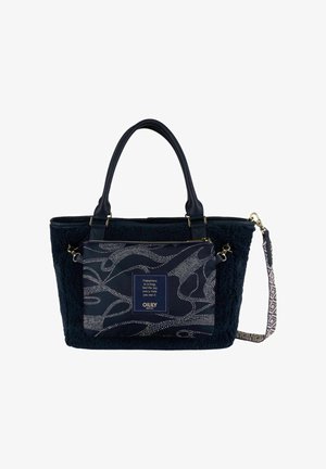 Sac fourre-tout noir texturé avec deux poignées, poche avant décorative affichant un motif abstrait à pois blancs et une bandoulière amovible à motif.