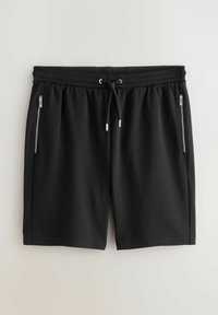 Sorte shorts lavet af blødt stof, med en elastisk talje og snøre samt to lynlåslommer på siden.