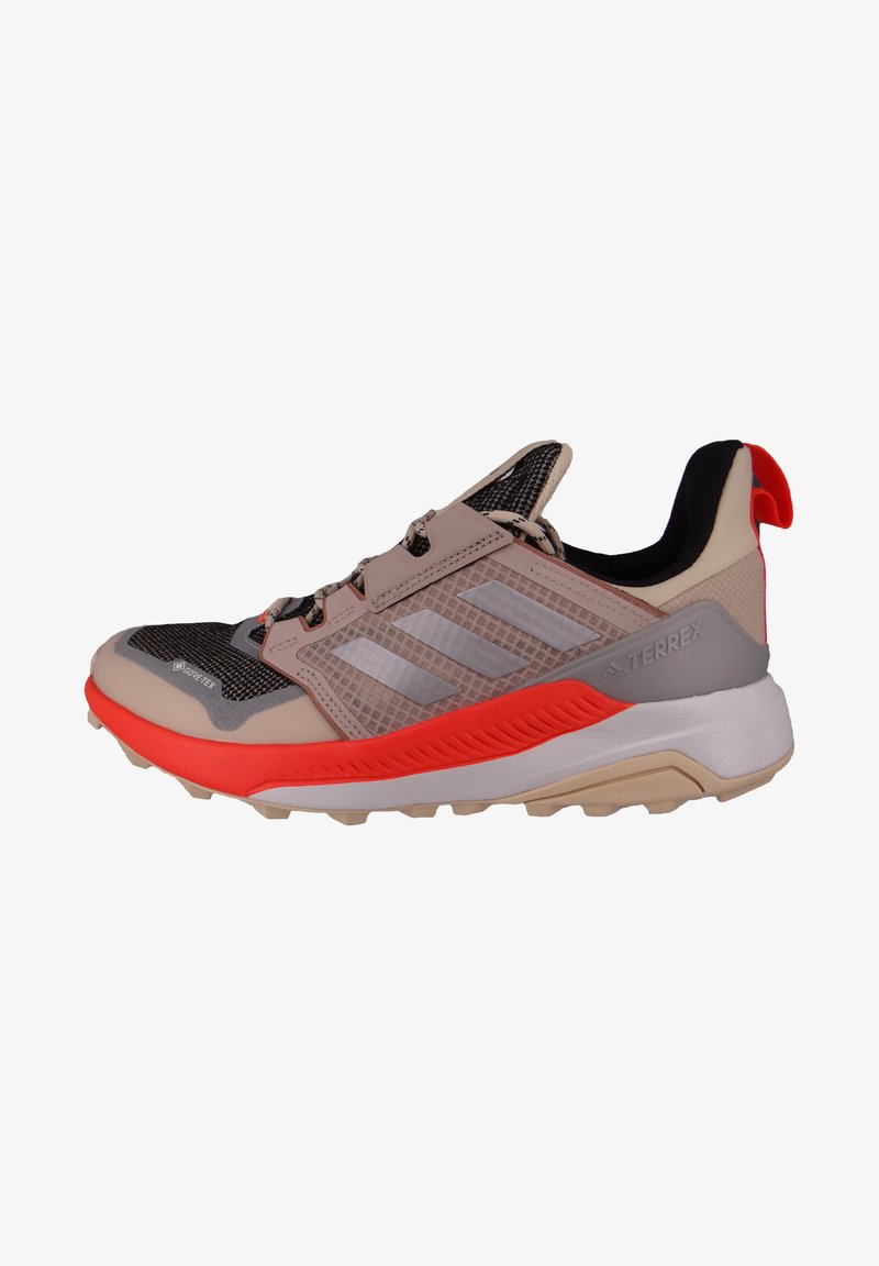 Lightweight trail running shoe with a mesh upper, gray and peach tones, textured midsole, and orange accents; features a pull tab at the heel.