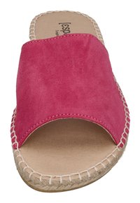 Pink suede slide sandal with a closed toe design, featuring a braided jute sole and stitching along the edges for texture and detail.