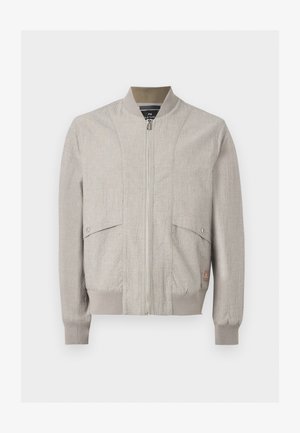 Veste bomber beige clair avec fermeture éclair à l'avant, col, poignets et bas côtelés, et deux poches à rabat pressionnées sur le devant.