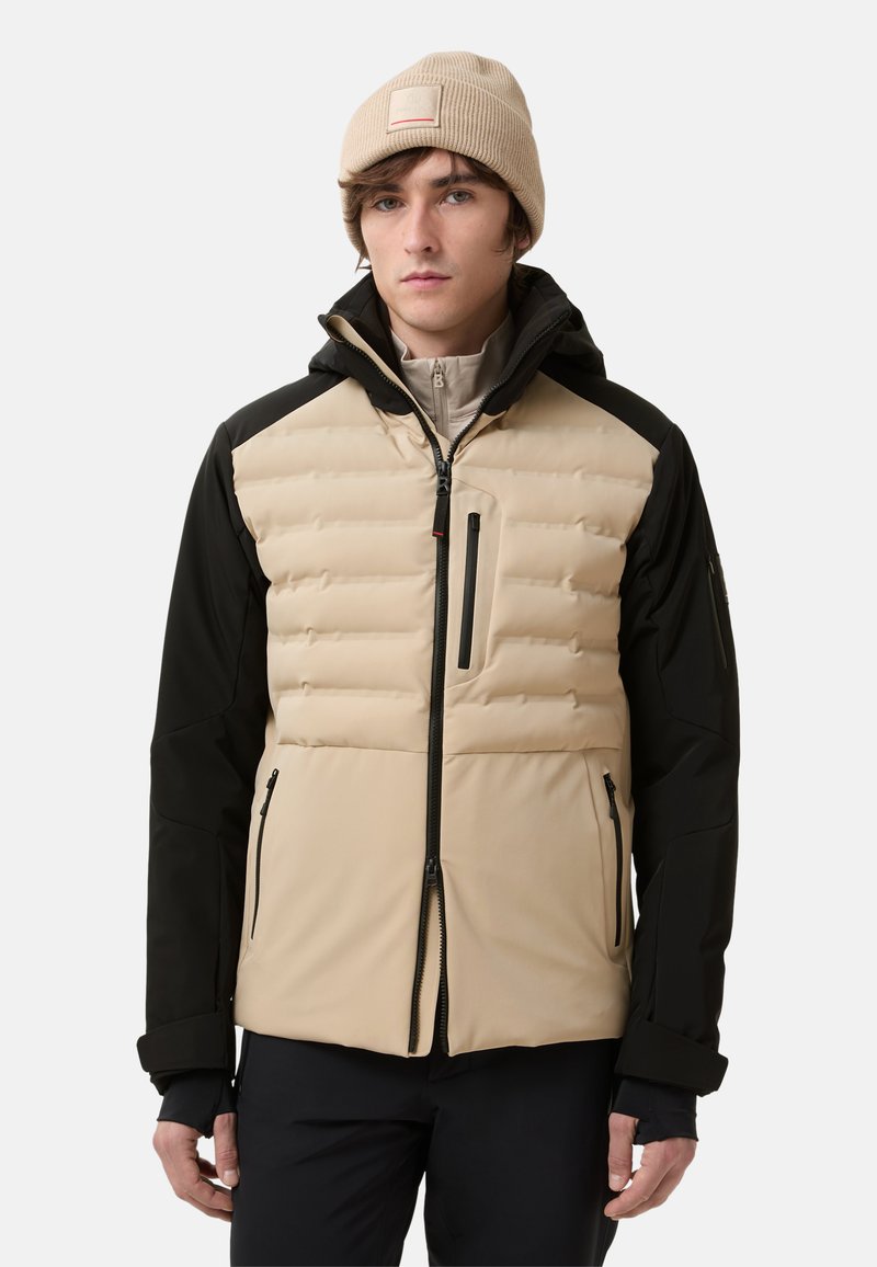 Gevoerde jas met een beige voorkant en zwarte mouwen. Bevat ritszakken, een capuchon en een geribbelde beige beanie. Textuurstof.