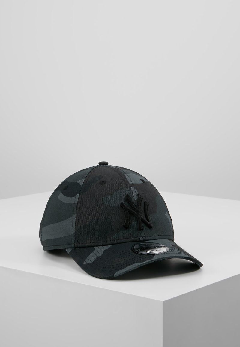 Black camo baseball cap featuring an embroidered logo, rounded crown, curved brim, and a smooth fabric texture.