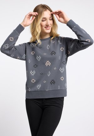 Gray patterned sweatshirt with varying diamond shapes in black, gray, and light peach. Features a crew neckline and ribbed cuffs.