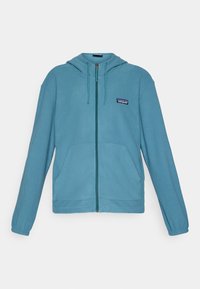 Light blue zip-up hoodie made of fleece material. Features a hood, two front pockets, and a small logo patch on the left chest.