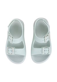 Light green sandals made of smooth material, featuring two adjustable buckles, open toe design, and textured soles.