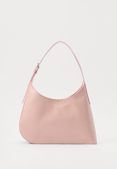 Pink leather handbag with a curved, asymmetrical shape, a single shoulder strap, and silver text detail on the front. Smooth texture.