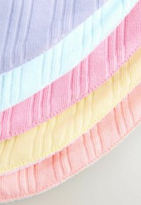 Four textured fabric strips in pastel colors: lavender, light blue, soft pink, and pale yellow, with ribbed patterns and visible stitching.