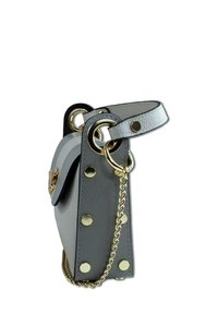 Gray leather handbag with gold hardware, circular rings, and decorative studs. Features a short strap and a chain accent on the side.