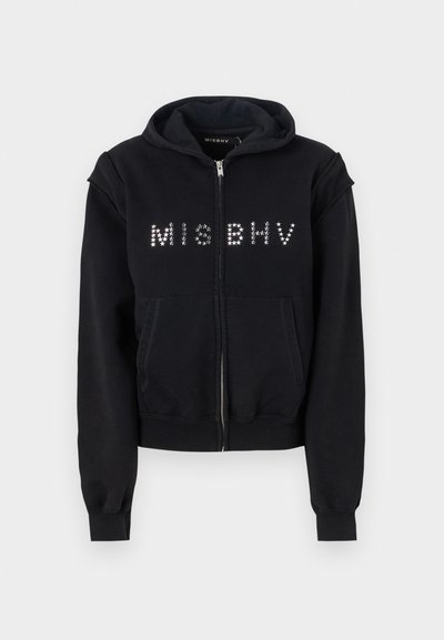 Black zip-up hoodie made of soft fabric, featuring a ribbed hem, two front pockets, and silver star embellishments spelling "MISBHV."