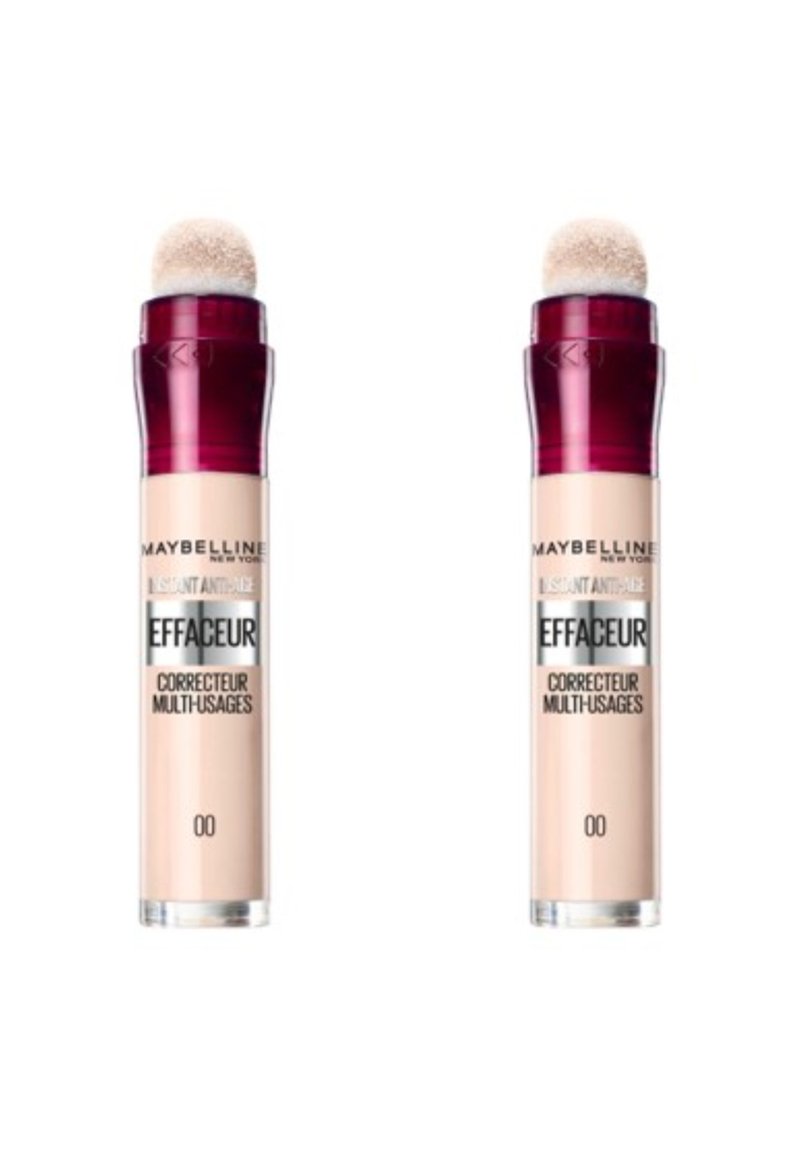 Correcteur anti-âge instantané Maybelline dans un flacon cylindrique. Il dispose d'un applicateur en éponge arrondi. Couleur beige clair avec un capuchon rouge foncé.