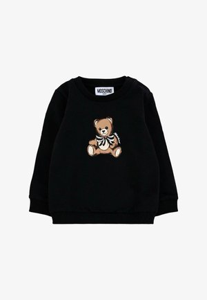 Sweatshirt noir en tissu doux avec des poignets et un col côtelés. Présentant un imprimé d'ours avec un nœud papillon à l'avant. Étiquette de la marque au niveau du cou.