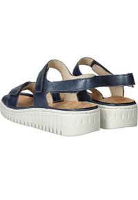 Marine leren sandalen met open achterkant, twee verstelbare banden en een gestructureerde witte platformzool. Van binnen heeft het een kurken inlegzool.