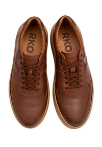 Brązowe skórzane trampki z okrągłym noskiem, teksturowaną powierzchnią i kontrastującą gumową podeszwą. Posiadają sznurowane zapięcie i logo RKO.