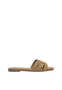Tan suede slide sandal featuring a crossed strap design, flat sole, and minimalistic construction, ideal for casual wear.