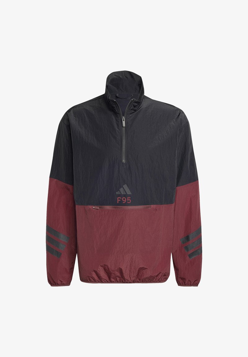 Coupe-vent Adidas noir et rouge foncé avec demi-fermeture éclair, poche zippée avant, poignets élastiques, et logo F95 sous la poitrine.