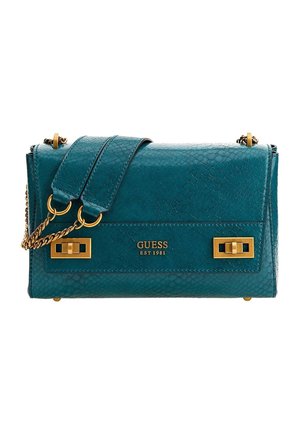 Teal textured leather Guess shoulder bag with gold chain strap, gold hardware, and front logo stating "GUESS EST 1981."