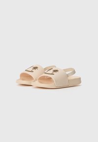 Sandali scivolati in tonalità pesca e crema con design open toe e ricamo di palme. Tessuto morbido con suola piatta e cinturino elastico sul retro.