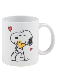 White ceramic mug featuring a cartoon dog with a black ear, holding a small bird. Design includes two red hearts and simple line art details.