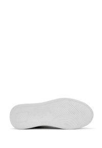 Semelle de chaussure en caoutchouc blanc avec surface texturée et rainures diagonales. Bord avant arrondi et zone de talon légèrement surélevée. Aucune marque visible.