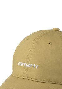 Gorra de algodón beige con una corona redondeada, logo "carhartt" bordado en blanco en la parte frontal, y detalles de costura en contraste.