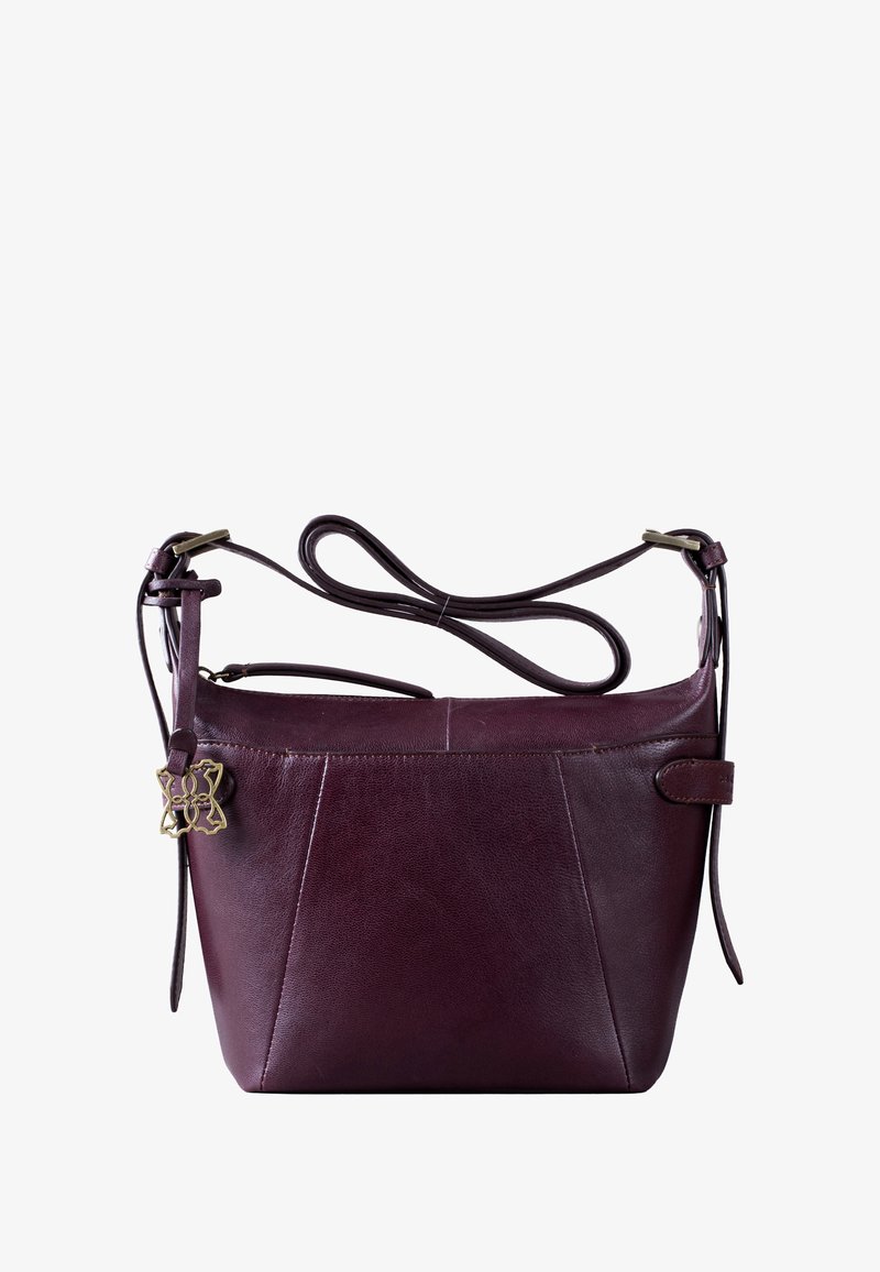 Dark burgundy leather handbag with an adjustable strap and a decorative gold hardware accent. Features a structured shape and minimalistic design.