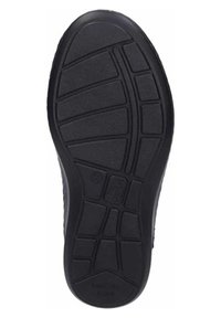 Black rubber shoe sole with a textured surface; features grooves and patterns for traction; slightly rounded heel for flexibility.
