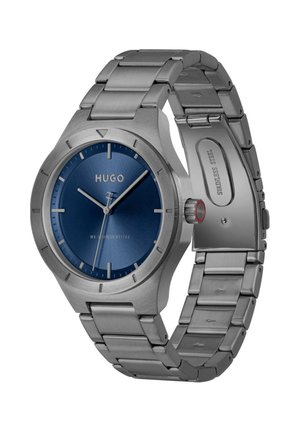 Polshorloge van roestvrij staal met blauwe wijzerplaat, zilveren uurmarkeringen, drie wijzers en een metalen schakelsluiting die openstaat.