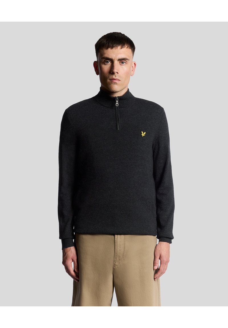 Mörkgrå, zip-up tröja med ståkrage och ribbade ärmslut. Har en liten gul logotyp på br�östet. Tillverkad av ett texturerat tyg.