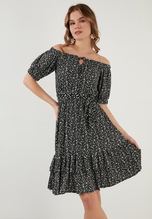 Zwart bloemenpatroon jurk met off-shoulder ontwerp, pofmouwen, een keyhole-detail bij de halslijn en een gelaagde rucheszoom.
