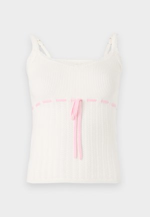 Camisola branca de alças canelada com um design ajustado, apresentando uma cintura com cordão rosa e acabamento em renda nas alças. Texturizada com um padrão subtil.
